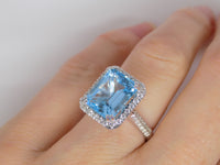 9ct White Gold Rectangle Blue Topaz & Diamond Halo Ring SKU 5506004