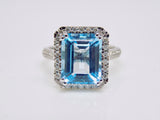 9ct White Gold Rectangle Blue Topaz & Diamond Halo Ring SKU 5506004